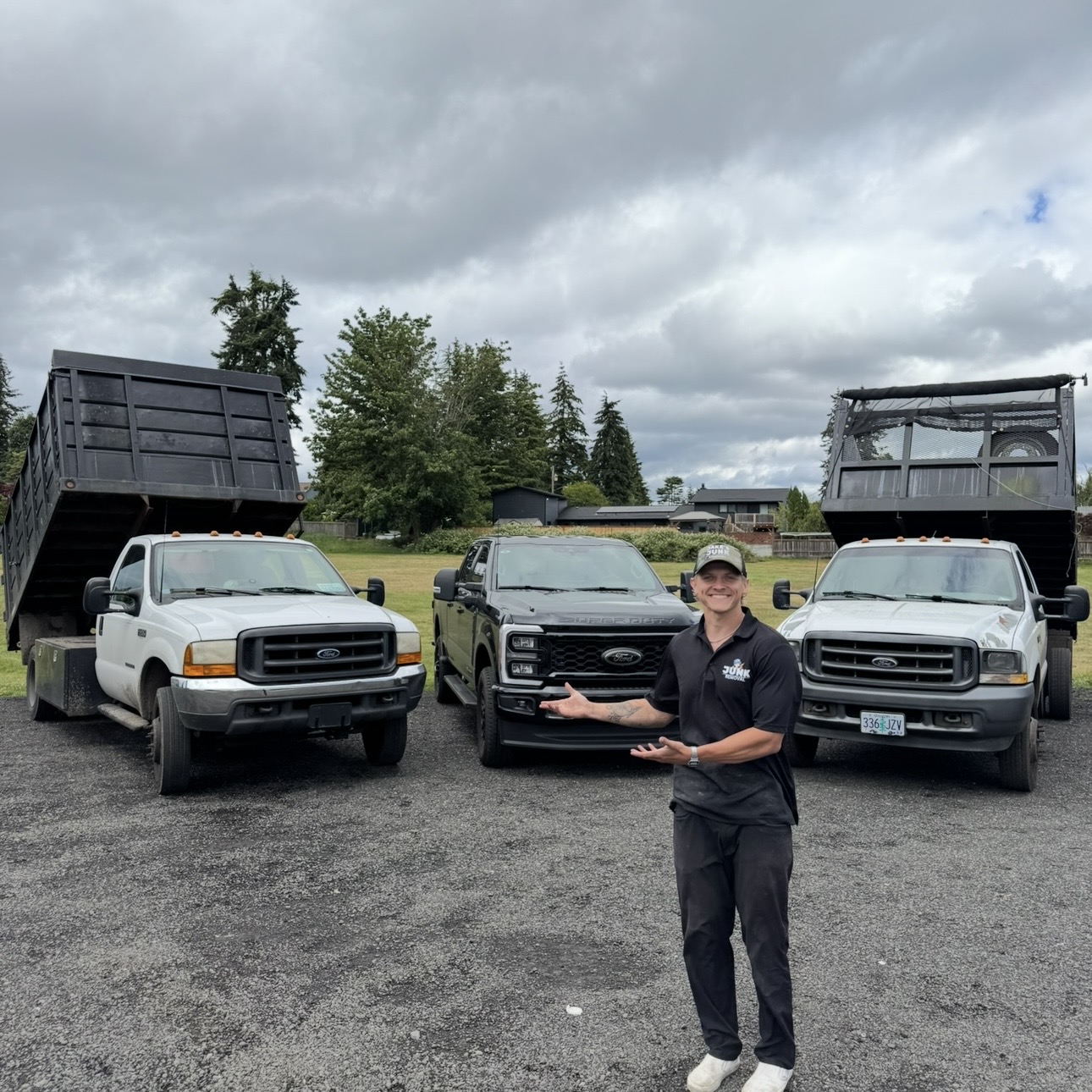 Jake in front of the Jake's Junk Removal trucks